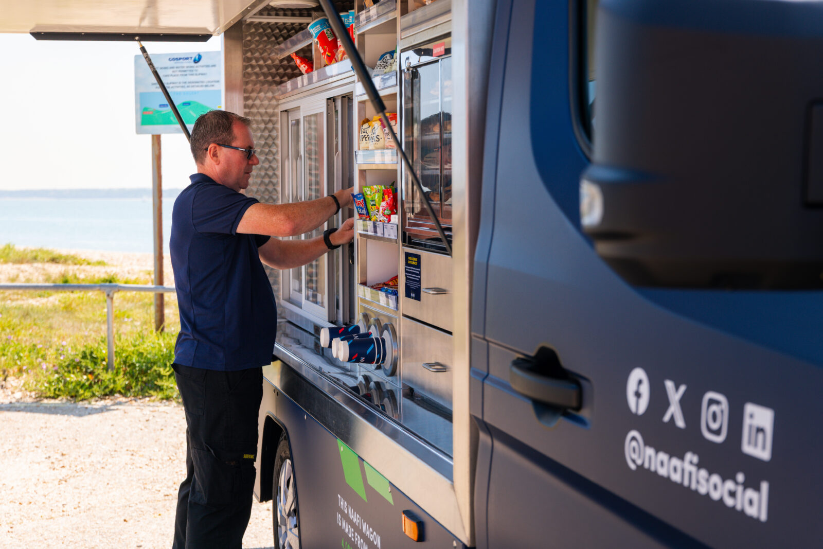 NAAFI staff member filling the NAAFI wagon